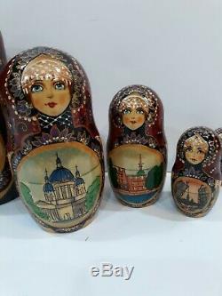 Russian Matryoshka nesting dolls SIGNED 7 piece Burgundy Gold Various Buildings